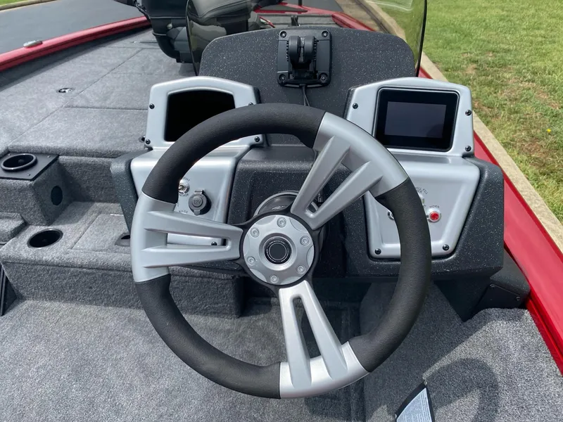 Slide: The Image of 2025 Tracker Pro Team 195 Tournament Edition boat dashboard with steering wheel and dual displays. - 13