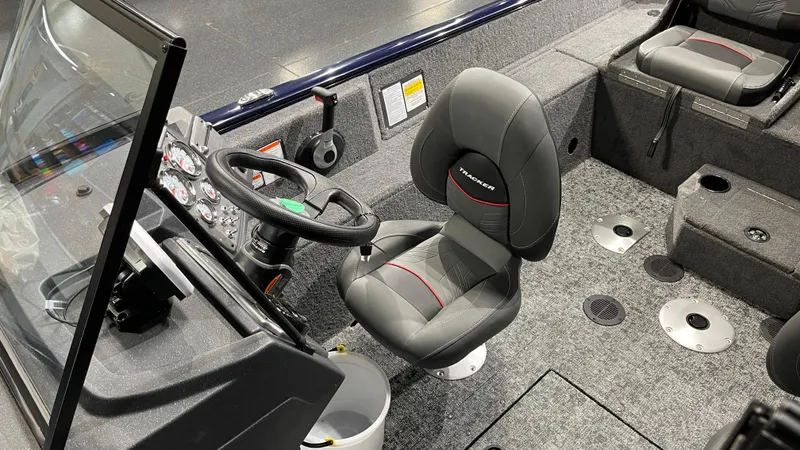 Slide: The Image of 2025 Tracker Pro Guide V-175 Combo boat interior with steering wheel and seating. - 13