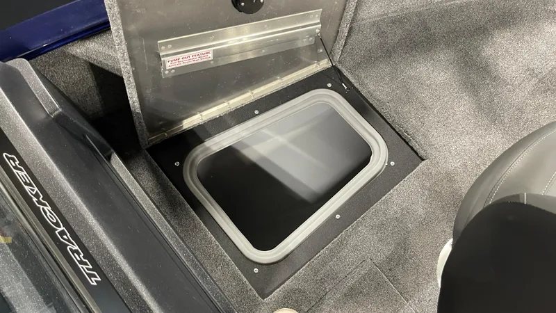 Slide: The Image of 2025 Tracker Pro Guide V-175 Combo boat storage compartment with carpeted interior. - 16