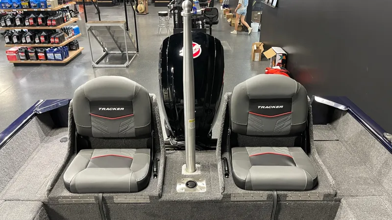 Slide: The Image of 2025 Tracker Pro Guide V-175 Combo boat interior with two seats and motor. - 18