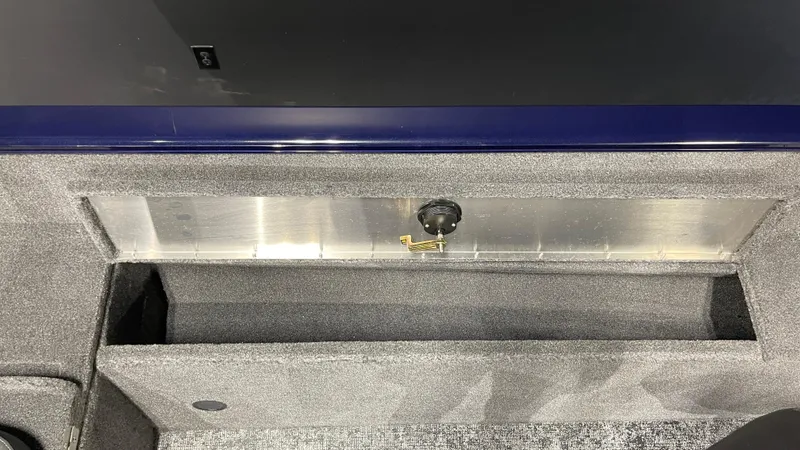 Slide: The Image of 2025 Tracker Pro Guide V-175 Combo storage compartment with secure latch. - 20