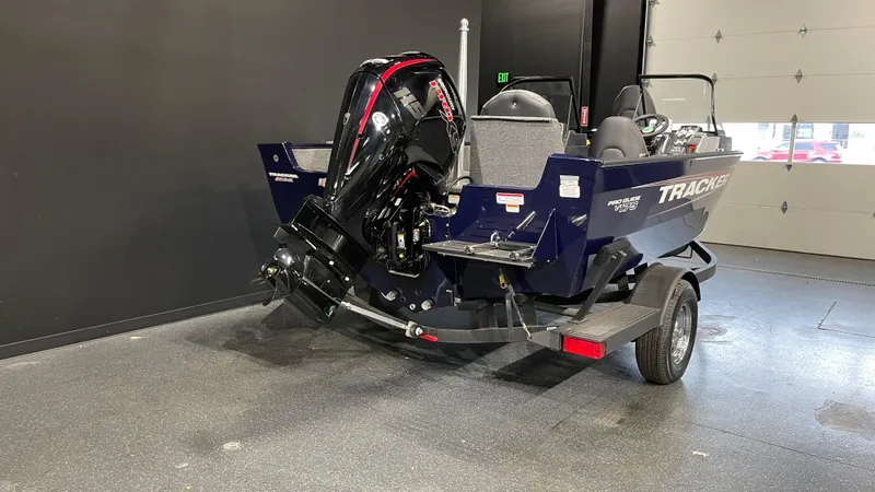 Slide: The Image of 2025 Tracker Pro Guide V-175 Combo boat in showroom, rear view. - 3