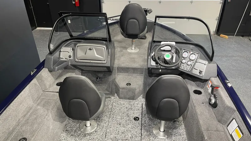 Slide: The Image of 2025 Tracker Pro Guide V-175 Combo boat interior with dual consoles and seating. - 7