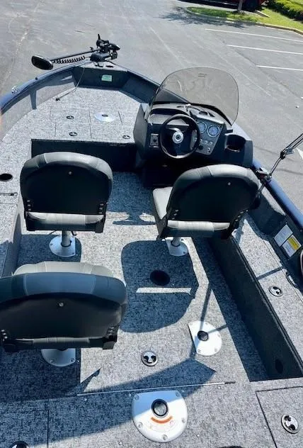 Slide: The Image of 2025 Tracker Pro Guide V-16 SC boat interior with seating and steering console. - 3