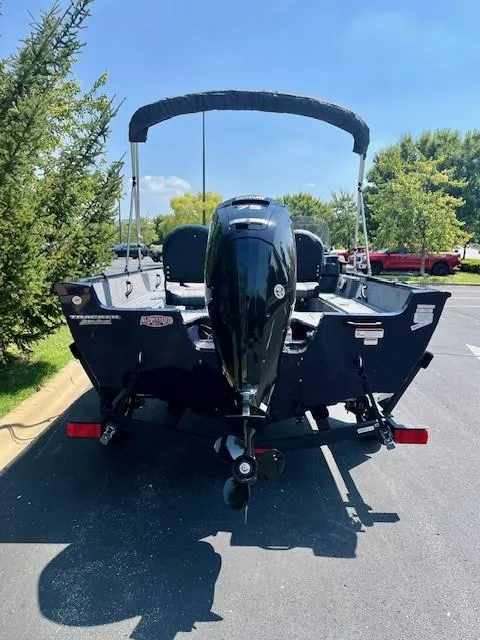Slide: The Image of 2025 Tracker Pro Guide V-16 SC boat, rear view, parked outdoors. - 5