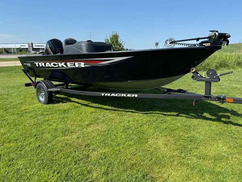Slide: The Image of 2025 Tracker Pro Guide V-16 SC boat on trailer, parked on grass. - 3