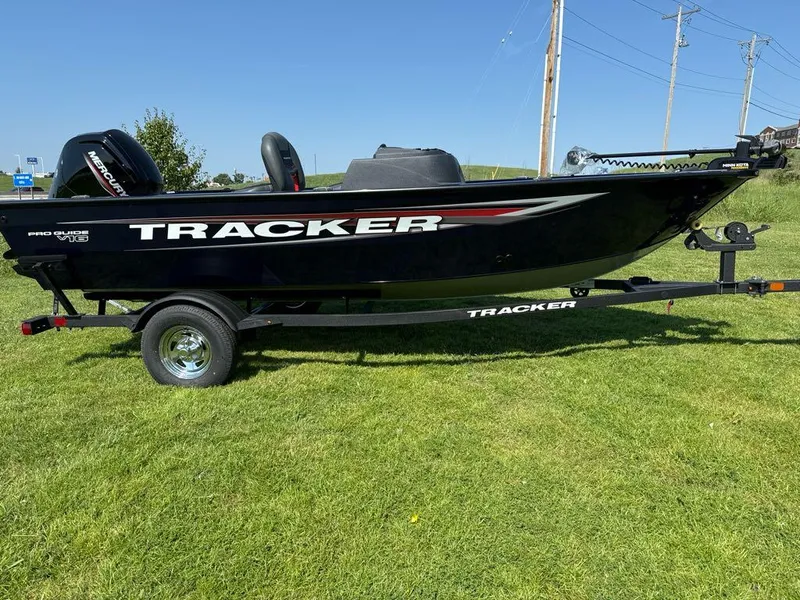 Slide: The Image of 2025 Tracker Pro Guide V-16 SC boat on grassy field. - 4