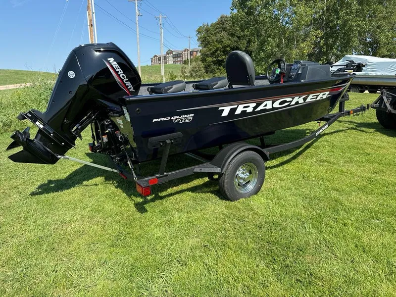 Slide: The Image of 2025 Tracker Pro Guide V-16 SC boat on grass, featuring a Mercury outboard motor. - 5