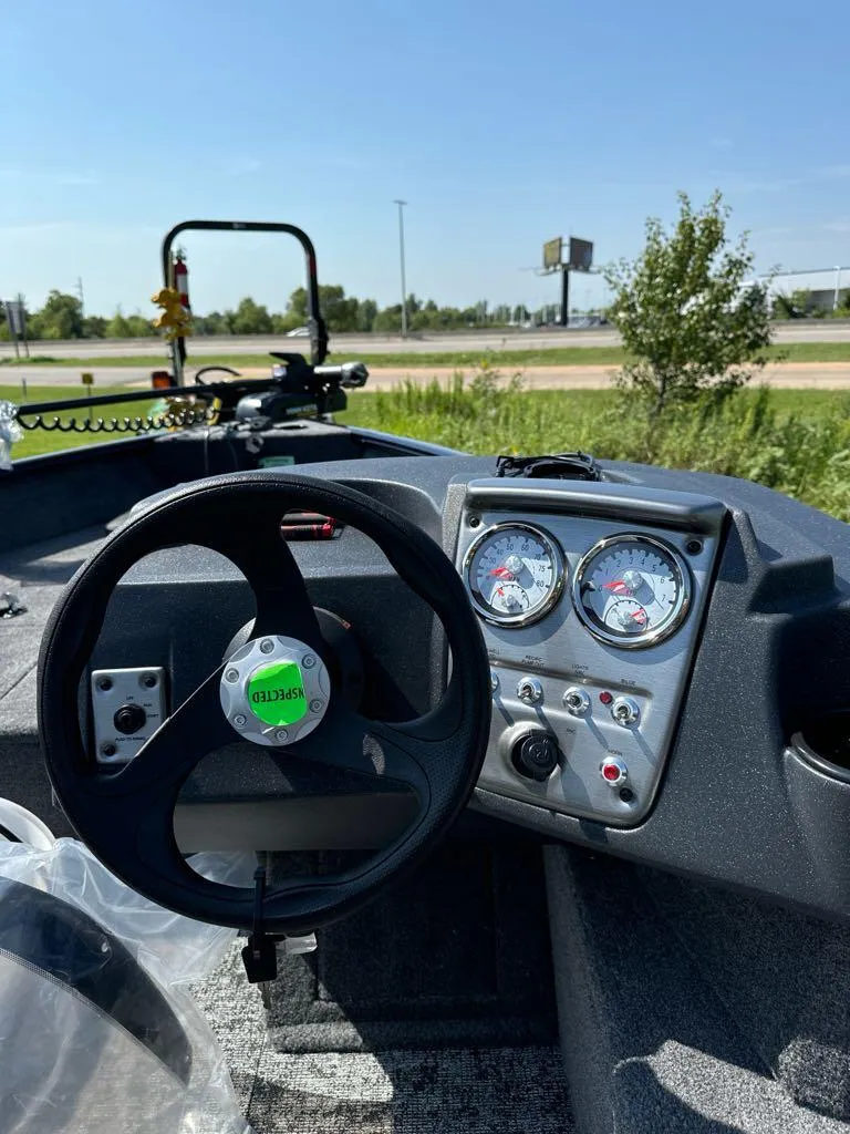 Slide: The Image of 2025 Tracker Pro Guide V-16 SC boat dashboard with steering wheel and gauges. - 7