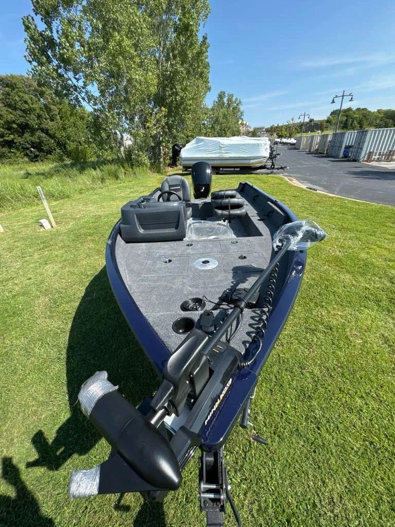 Slide: The Image of 2025 Tracker Pro Guide V-16 SC boat on grassy area, sunny day. - 8