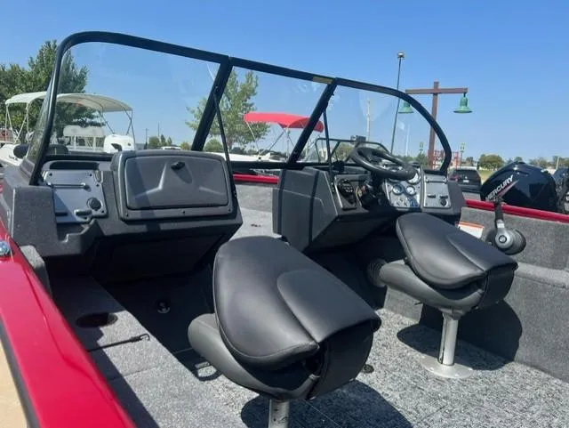 Slide: The Image of 2025 Tracker Pro Guide V-175 Combo boat interior with dual seats and steering console. - 2