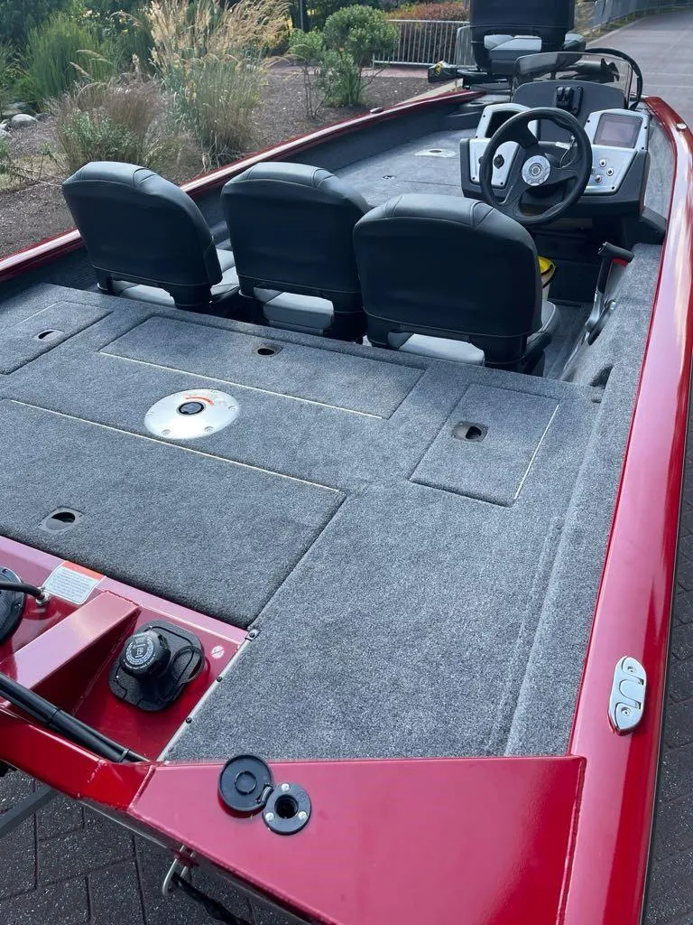 Slide: The Image of 2025 Tracker Pro Team 175 Crappie Edition boat with red exterior and spacious seating. - 3