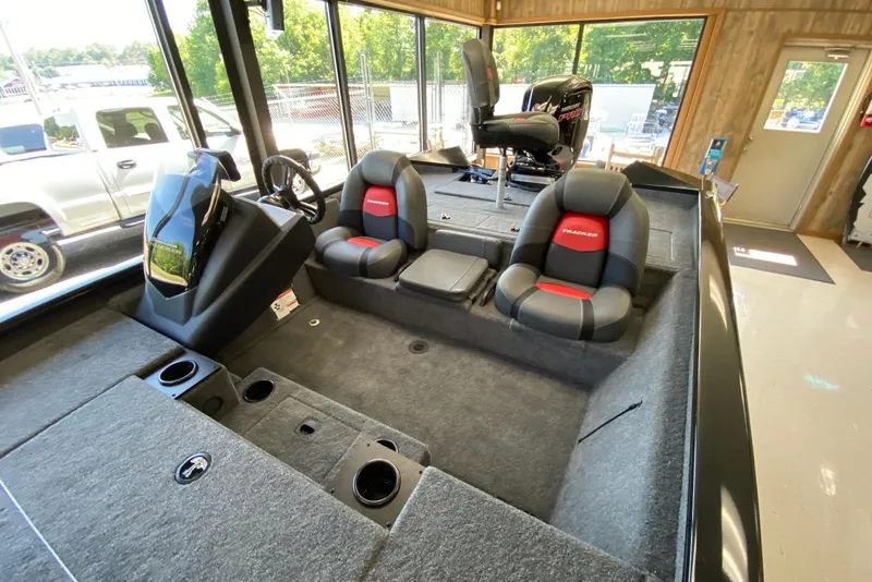 Slide: The Image of 2025 Tracker Pro Team 195 Tournament Edition boat interior with seating and steering console. - 11