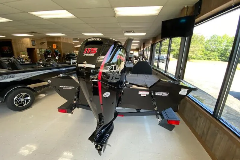 Slide: The Image of 2025 Tracker Pro Team 195 Tournament Edition boat with Mercury 115 engine in showroom. - 8