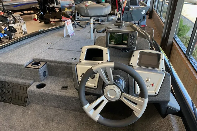 Slide: The Image of 2025 Tracker Pro Team 195 Tournament Edition boat dashboard with steering wheel and electronic displays. - 9