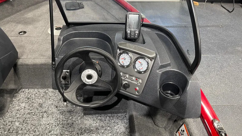 Slide: The Image of 2025 Tracker Pro Guide V-16 WT boat dashboard with steering wheel and gauges. - 10