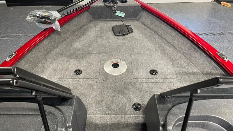 Slide: The Image of 2025 Tracker Pro Guide V-16 WT boat interior with red trim and spacious deck. - 13