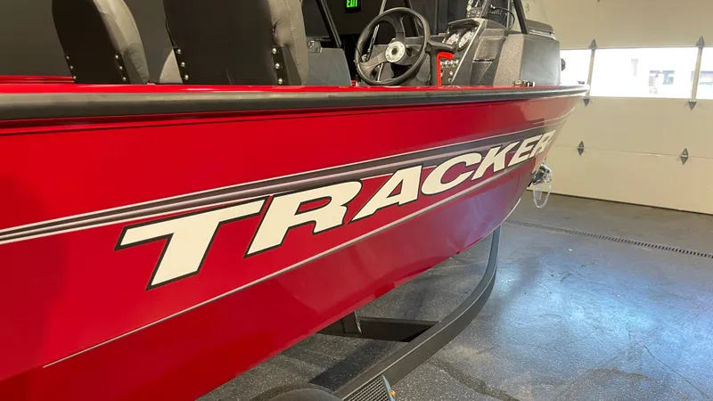 Slide: The Image of 2025 Tracker Pro Guide V-16 WT boat in vibrant red, indoor showroom display. - 6