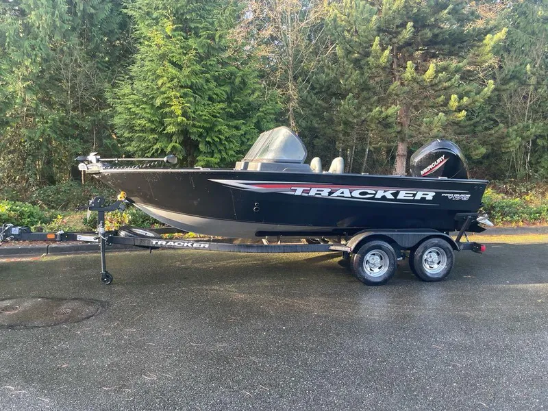 The Image of 2025 Tracker Pro Guide V-175 Combo boat on trailer, parked outdoors. - 0