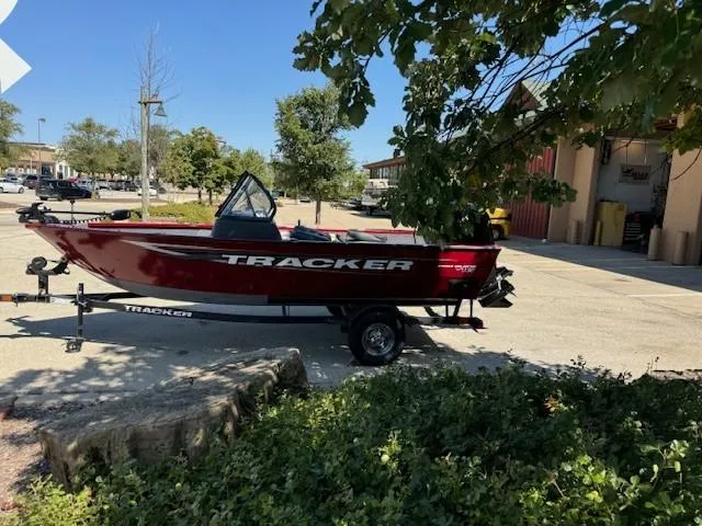 Slide: The Image of 2025 Tracker Pro Guide V-16 WT boat on trailer, parked outdoors. - 3