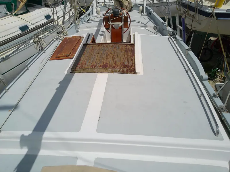 Slide: The Image of 1978 Downeast 38 sailboat deck with wooden hatch and steering wheel. - 15