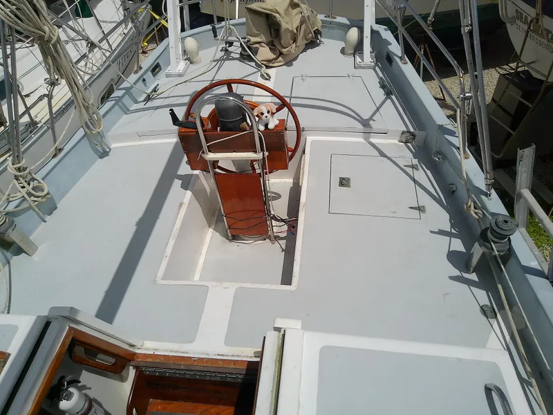 Slide: The Image of 1978 Downeast 38 sailboat deck with steering wheel and rigging. - 16