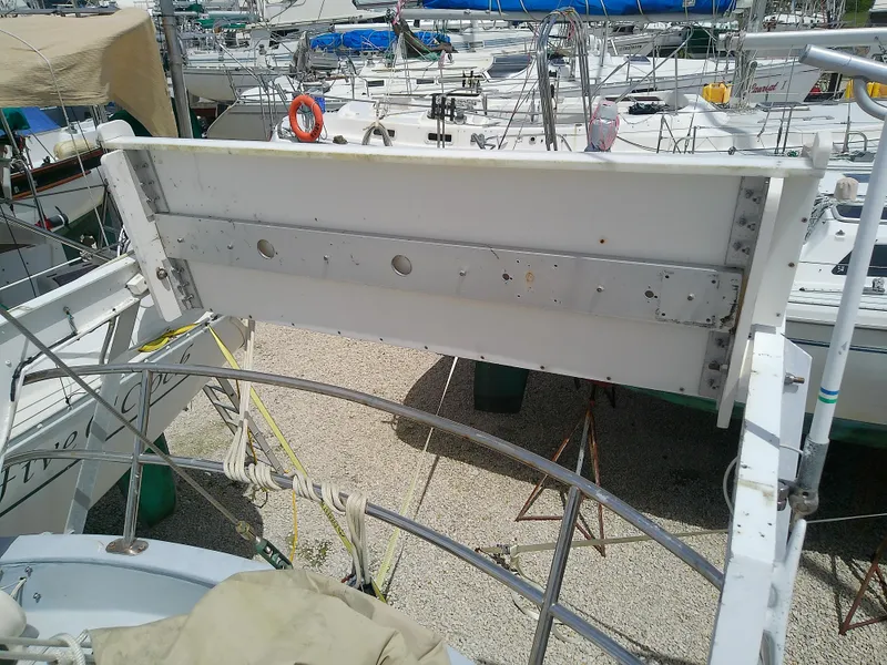 Slide: The Image of 1978 Downeast 38 sailboat deck with railing and equipment in a marina. - 18