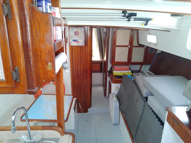 Slide: The Image of 1978 Downeast 38 sailboat interior with wood cabinetry and cozy sleeping area. - 23