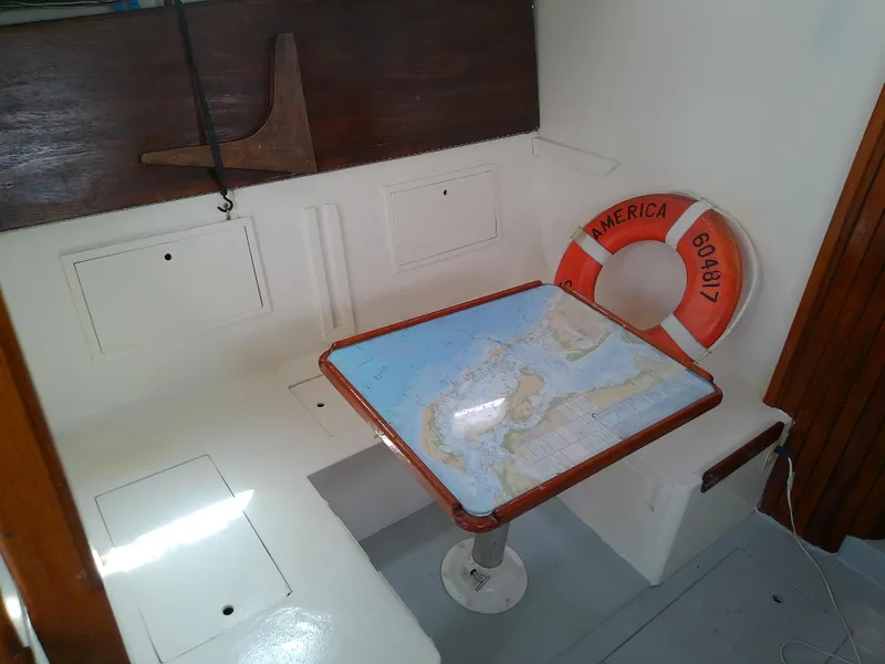 Slide: The Image of 1978 Downeast 38 boat interior with map table and life preserver. - 24