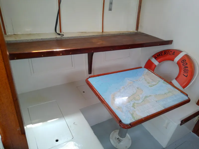 Slide: The Image of 1978 Downeast 38 boat interior with map table and life preserver. - 25