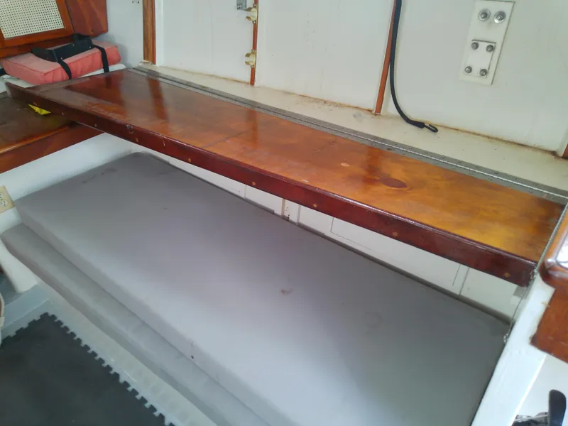 Slide: The Image of 1978 Downeast 38 interior with wooden shelf and cushioned bench. - 29