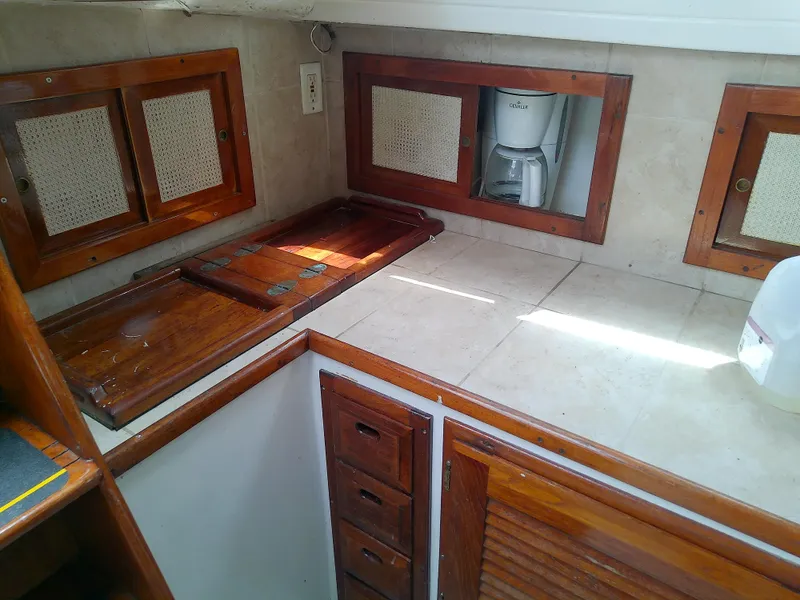 Slide: The Image of 1978 Downeast 38 yacht kitchen with wooden cabinets and countertop. - 30