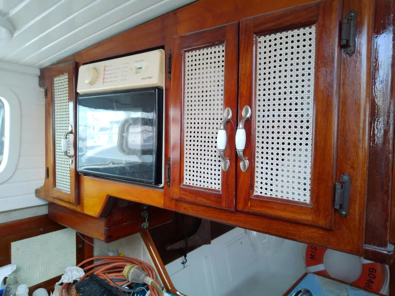 Slide: The Image of Vintage 1978 Downeast 38 yacht interior with wooden cabinets and built-in microwave. - 33