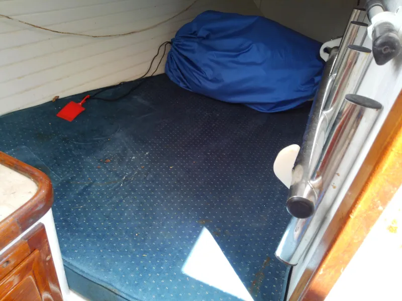 Slide: The Image of Interior cabin of 1978 Downeast 38 boat with blue bedding and wooden cabinetry. - 39