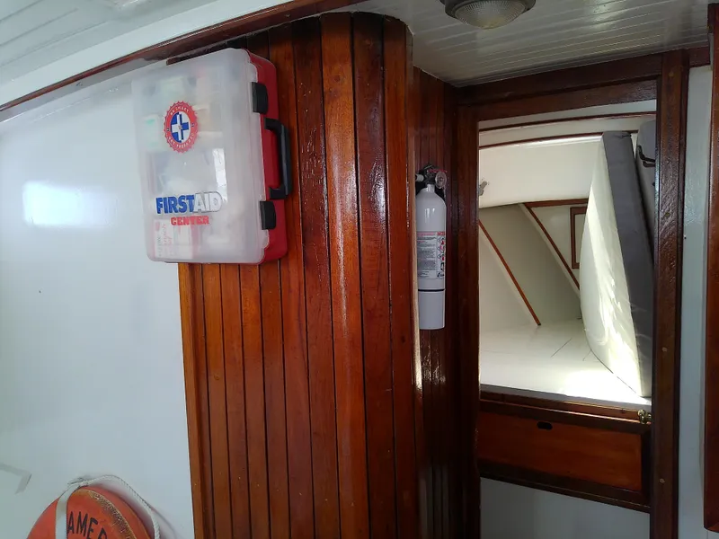 Slide: The Image of 1978 Downeast 38 boat interior with first aid kit and fire extinguisher. - 40