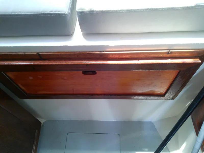 Slide: The Image of Interior of 1978 Downeast 38 boat with wooden paneling and cushioned seating. - 44