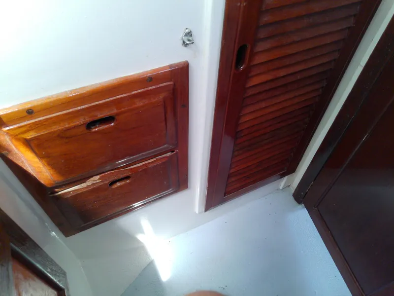 Slide: The Image of 1978 Downeast 38 interior with wooden cabinets and doors. - 46