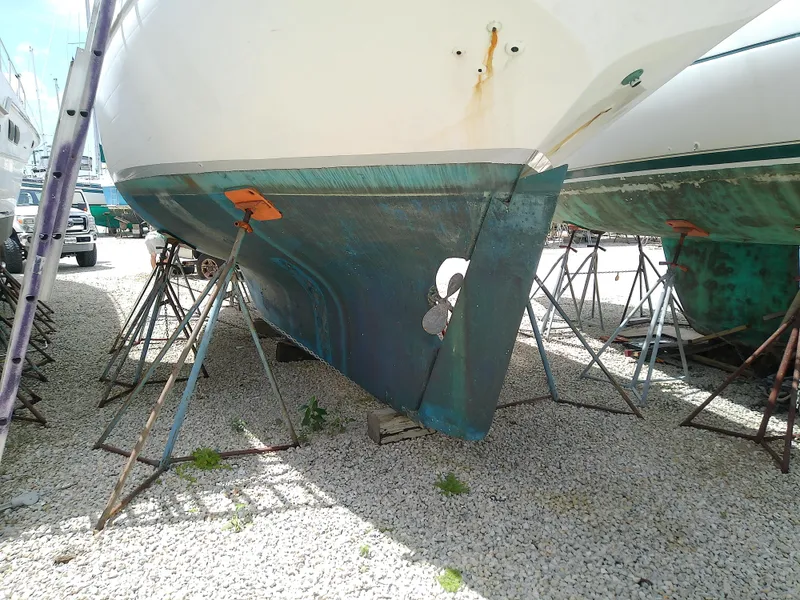 Slide: The Image of 1978 Downeast 38 sailboat hull on stands in a boatyard. - 6