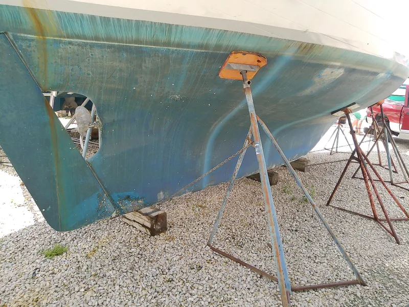 Slide: The Image of 1978 Downeast 38 boat hull on stands, showing propeller and keel. - 7