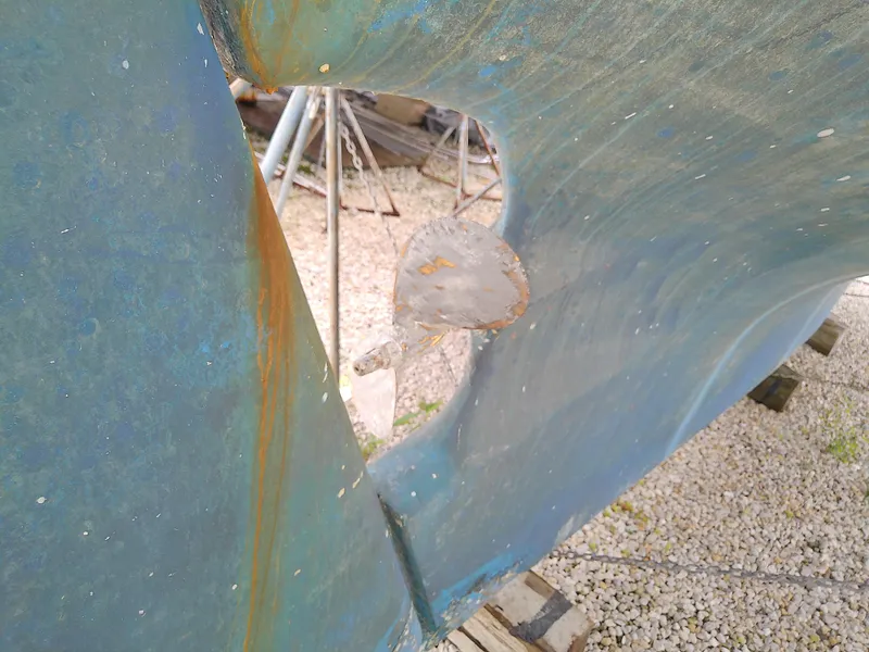 Slide: The Image of Close-up of 1978 Downeast 38 boat hull with visible rudder and propeller. - 8