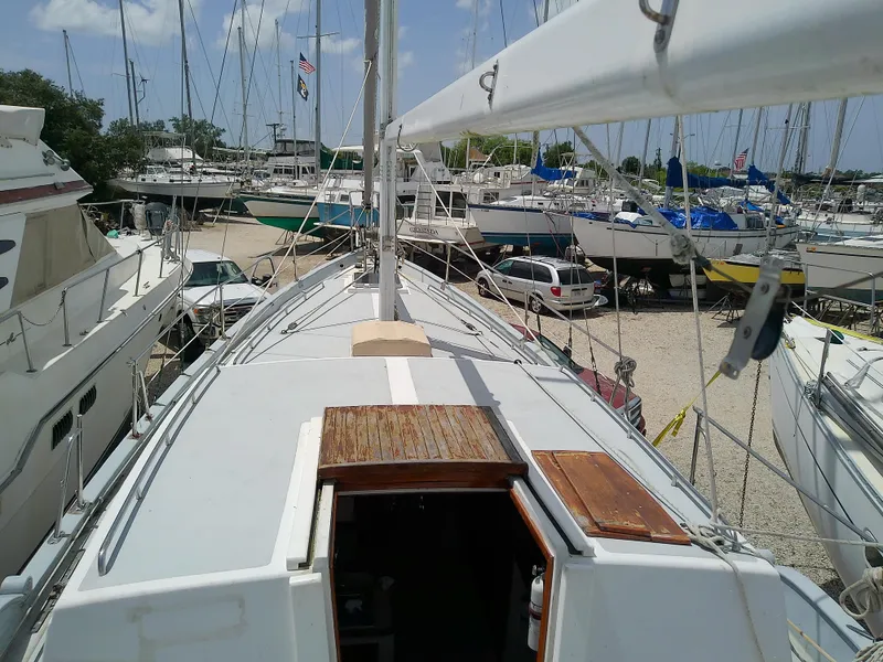Slide: The Image of 1978 Downeast 38 sailboat docked in a marina, surrounded by other boats. - 9