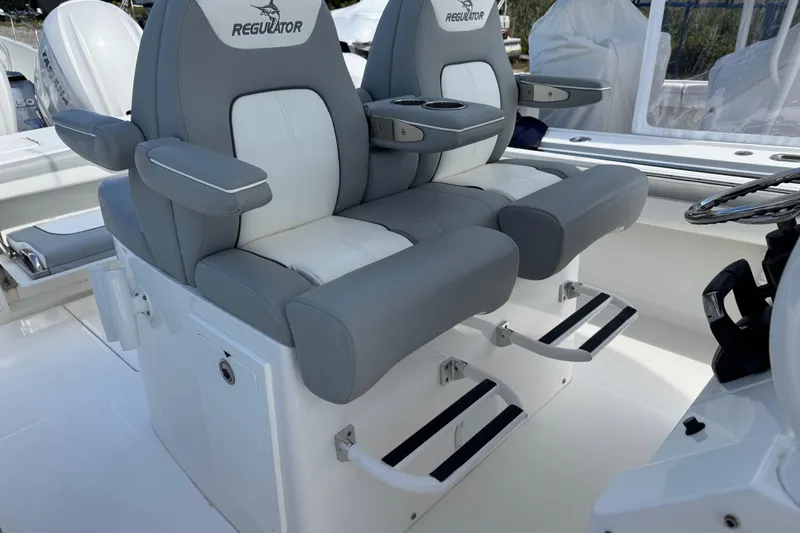 Slide: The Image of 2022 Regulator 31 boat with advanced navigation equipment, docked in a marina. - 10