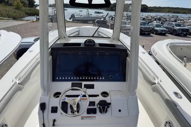 Slide: The Image of 2022 Regulator 31 boat interior with seating and console under a blue sky. - 17