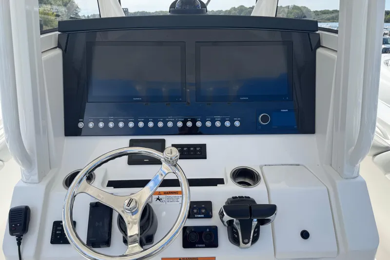Slide: The Image of 2022 Regulator 31 boat interior with dual seats and storage compartment. - 18