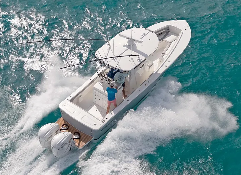 Slide: The Image of Storage compartments on a 2022 Regulator 31 boat, featuring organized tackle boxes and a red case. - 27