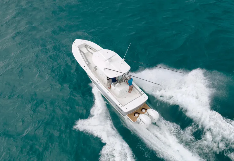 Slide: The Image of 2022 Regulator 31 boat cruising on open water, aerial view. - 32