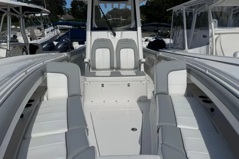 Slide: The Image of 2022 Regulator 31 boat with Yamaha engine, docked under clear blue sky. - 6