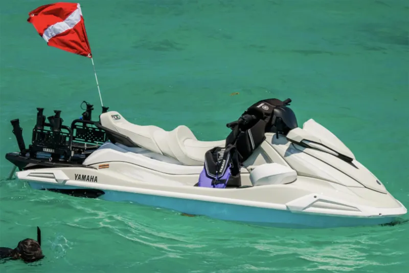 Slide: The Image of 2025 Yamaha WaveRunner VX Cruiser HO in showroom, blue color, displayed with other models. - 2