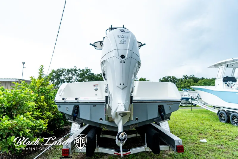 Slide: The Image of 2025 Pathfinder Open 2400 boat on trailer, displayed outdoors by Black Label Marine Group. - 1