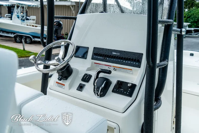 Slide: The Image of Control panel of 2025 Pathfinder Open 2400 boat with steering wheel and controls. - 10